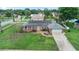 Stunning aerial view of a well-maintained house featuring solar panels, a spacious lawn, and a paved driveway at 800 Black Duck Dr, Port Orange, FL 32127