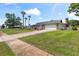 This inviting home includes a well-kept lawn, mature trees, and an extended driveway at 800 Black Duck Dr, Port Orange, FL 32127