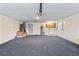 Spacious carpeted garage, featuring an air conditioner, utility sink and door at 800 Black Duck Dr, Port Orange, FL 32127