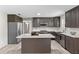 Renovated kitchen features stainless steel appliances, island with quartz countertops, and stylish backsplash at 800 Black Duck Dr, Port Orange, FL 32127