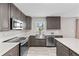 This kitchen features stainless appliances, a farmhouse sink, ample cabinets, and elegant countertops at 800 Black Duck Dr, Port Orange, FL 32127