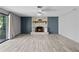 Bright living room with stylish fireplace, ceiling fan, and sliding glass doors to the patio at 800 Black Duck Dr, Port Orange, FL 32127