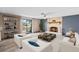 This staged living room has a decorative fireplace, sliding glass doors to a patio, seating, and shelving at 800 Black Duck Dr, Port Orange, FL 32127