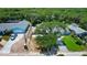 Aerial view of a landscaped property with a spacious layout and mature trees, showcasing the neighborhood at 805 E 18Th Ave, New Smyrna Beach, FL 32169