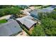 Charming pink single-Gathering home with a gray roof surrounded by mature trees and a well-maintained landscape at 805 E 18Th Ave, New Smyrna Beach, FL 32169