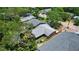 This aerial shot captures a cozy home nestled amongst lush greenery, offering a serene and private setting at 805 E 18Th Ave, New Smyrna Beach, FL 32169