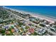 Expansive aerial view of a charming coastal community, showcasing beachfront homes and serene surroundings at 805 E 18Th Ave, New Smyrna Beach, FL 32169