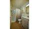 Bathroom with shower, gray vanity, toilet and built in shelving at 805 E 18Th Ave, New Smyrna Beach, FL 32169