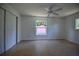Bright bedroom with tile flooring, ceiling fan, and view of pink shed in backyard at 805 E 18Th Ave, New Smyrna Beach, FL 32169