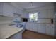 Well-equipped kitchen with white cabinetry, stainless steel appliances, and tile flooring at 805 E 18Th Ave, New Smyrna Beach, FL 32169