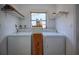 Bright laundry room with washer, dryer, and shelving, providing convenience for laundry tasks at 805 E 18Th Ave, New Smyrna Beach, FL 32169