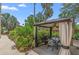 Lush backyard retreat boasting outdoor dining area, a grill, and a charming gazebo surrounded by greenery at 807 Craig St, New Smyrna Beach, FL 32168