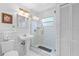Clean bathroom with white tiled walls and a glass-enclosed shower, offering a modern and spacious feel at 807 Craig St, New Smyrna Beach, FL 32168