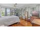 Bright bedroom boasts hardwood floors, multiple windows with curtains, and a cozy, relaxing atmosphere at 807 Craig St, New Smyrna Beach, FL 32168