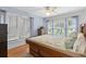 Serene bedroom with hardwood floors, three large windows, and calming blue walls at 807 Craig St, New Smyrna Beach, FL 32168