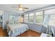 Inviting bedroom features wood floors, large windows, and beachy decor at 807 Craig St, New Smyrna Beach, FL 32168