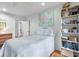 Airy bedroom featuring a bed, soft lighting, and decorative shelving, creating a tranquil retreat at 807 Craig St, New Smyrna Beach, FL 32168