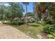 View of the home's exterior showing its landscaped front yard and gravel driveway at 807 Craig St, New Smyrna Beach, FL 32168