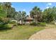 Charming home's exterior with mature landscaping and a circular gravel driveway at 807 Craig St, New Smyrna Beach, FL 32168
