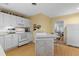 Bright kitchen featuring white cabinets, modern appliances, and a breakfast bar with wood floors at 807 Craig St, New Smyrna Beach, FL 32168