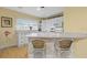 Bright kitchen featuring white cabinetry, a breakfast bar, and modern appliances at 807 Craig St, New Smyrna Beach, FL 32168