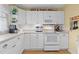 Well-lit kitchen featuring white appliances and cabinetry, with sleek countertops and subway tile backsplash at 807 Craig St, New Smyrna Beach, FL 32168
