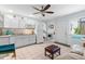 Bright kitchen boasts white cabinets, eat-in area, and is adjacent to a cozy living space at 807 Craig St, New Smyrna Beach, FL 32168