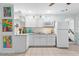 Bright kitchen with white cabinets, countertops, and backsplash offers a clean and modern aesthetic at 807 Craig St, New Smyrna Beach, FL 32168