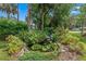 Picturesque pond with a small waterfall surrounded by lush landscaping and featuring water lilies and a birdhouse at 807 Craig St, New Smyrna Beach, FL 32168