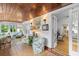 Bright sunroom featuring a wood ceiling, tiled floor, and multiple seating areas at 807 Craig St, New Smyrna Beach, FL 32168
