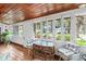 Bright sunroom with a tiled floor and many windows at 807 Craig St, New Smyrna Beach, FL 32168