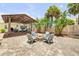 Beautiful backyard featuring a stone fire pit area and covered patio perfect for outdoor relaxation at 821 Ocean Ave, New Smyrna Beach, FL 32169