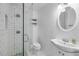 Bright bathroom features a walk-in shower with stylish blue and green patterned tiling and vanity with decorative mirror at 821 Ocean Ave, New Smyrna Beach, FL 32169