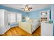 Cozy bedroom with shuttered windows, hardwood floors, and a decorative ceiling fan at 821 Ocean Ave, New Smyrna Beach, FL 32169