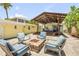 Inviting backyard firepit and covered patio area perfect for entertaining and outdoor relaxation at 821 Ocean Ave, New Smyrna Beach, FL 32169