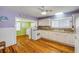 Charming kitchen featuring wooden floors, white cabinets, and colorful wall accents at 821 Ocean Ave, New Smyrna Beach, FL 32169
