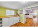 Eclectic eat-in kitchen with wood floors and cabinetry plus a large window at 821 Ocean Ave, New Smyrna Beach, FL 32169
