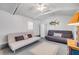 Cozy room with painted floor, vaulted ceilings, ceiling fan and two futons at 821 Ocean Ave, New Smyrna Beach, FL 32169