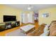 Comfortable living room featuring wood floors, a sofa, and easy access to other rooms at 821 Ocean Ave, New Smyrna Beach, FL 32169