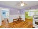 Charming living room with hardwood floors and colorful decor, featuring views into kitchen and bedroom at 821 Ocean Ave, New Smyrna Beach, FL 32169
