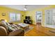 Cozy living room featuring wood floors, yellow walls, and ample natural light at 821 Ocean Ave, New Smyrna Beach, FL 32169