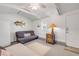 Living room with vaulted ceilings, ceiling fan, and futon at 821 Ocean Ave, New Smyrna Beach, FL 32169