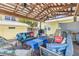 Comfortable seating under the pergola with palm trees, creating a relaxing outdoor space at 821 Ocean Ave, New Smyrna Beach, FL 32169