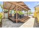 Backyard area with a wooden pergola with plenty of room to relax and grill at 821 Ocean Ave, New Smyrna Beach, FL 32169