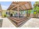 Pergola in backyard featuring a wooden structure, outdoor seating, and lush greenery at 821 Ocean Ave, New Smyrna Beach, FL 32169