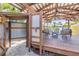 Pergola with an outdoor shower and seating area, perfect for backyard gatherings at 821 Ocean Ave, New Smyrna Beach, FL 32169