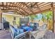 Outdoor lounge area with multiple sitting areas under a pergola for entertainment at 821 Ocean Ave, New Smyrna Beach, FL 32169