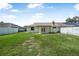 Generous backyard, featuring a covered patio, and white privacy fence at 837 Acorn Ln, Port Orange, FL 32127