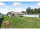 Expansive backyard with well-maintained lawn, patio, and privacy fencing at 837 Acorn Ln, Port Orange, FL 32127
