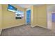 This bedroom features neutral carpet and a large window for natural light at 837 Acorn Ln, Port Orange, FL 32127